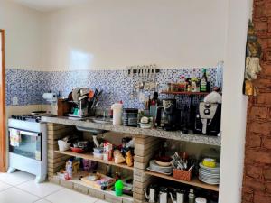 a kitchen with a counter with many items on it at Casa de Adobe in Lençóis