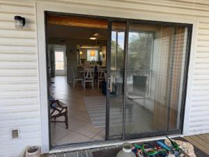 a sliding glass door of a house with a patio at Latitude 302 in Orange Beach