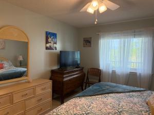 a bedroom with a bed and a dresser and a mirror at Latitude 302 in Orange Beach +17 photos