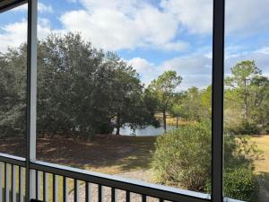 a window view of a lake from a porch at Latitude 302 in Orange Beach