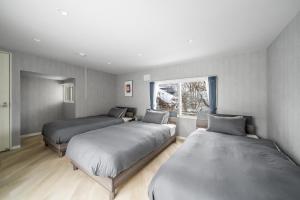 En eller flere senge i et værelse på Villas Park Kamifurano