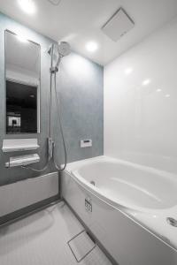 a bathroom with a bath tub and a sink at Villas Park Kamifurano in Kami-furano +99 photos