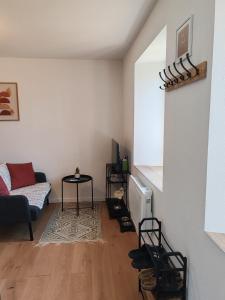 Cosy appartement calme et tout équipé idéal seul ou en couple في Seloncourt: غرفة معيشة بها أريكة وطاولة