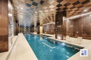 a swimming pool in a hotel lobby with a swimming pool at REST COLLECTION Apartments on Collins Docklands in Melbourne