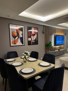 a dining room with a table and chairs at Gold Crest Prime Heights Executive Apartments-DHA Lahore in Lahore +105 photos