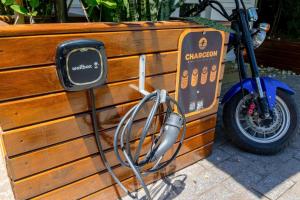 a motorcycle is parked next to a wooden wall at Suítes Jurerê Internacional in Florianópolis