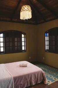 Ένα ή περισσότερα κρεβάτια σε δωμάτιο στο Casa com piscina Natural e vista panorâmica