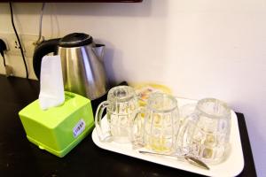 a table with a tray with glass mugs on it at Hotel Rasah Seremban in Seremban