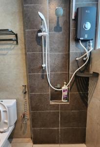 a shower in a bathroom with a toilet at Riverine Cozzy Resort RDA in Kuching +131 photos