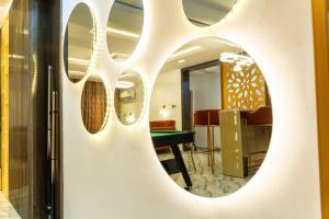 a mirror on a wall with a table in a room at Hapton apartment in Abuja