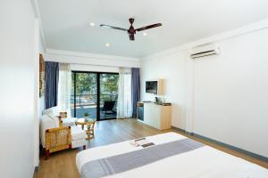 a bedroom with a bed and a living room at The Sanctuary Nam Ngum Beach Resort in Vang Vieng +59 photos