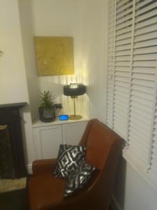 een woonkamer met een bank en een lamp bij Terrace cottage in Blackpool