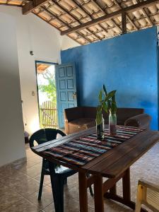 a wooden table with a plant on top of it at CANTINHO do SILENCIO in Morro de São Paulo