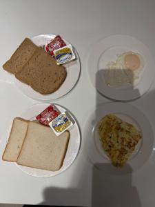 four plates with different types of bread and butter at Gold Crest Prime Heights Executive Apartments-DHA Lahore in Lahore