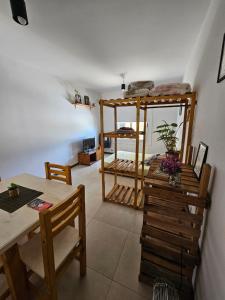 a living room with a table and a bunk bed at Amplio Departamento Monoambiente in San Luis +14 photos