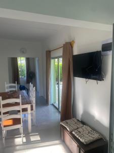a living room with a table and a dining room at La Camelia in Juan L. Lacaze