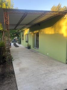 a building with awning on the side of it at La Camelia in Juan L. Lacaze