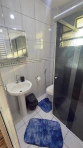 a bathroom with a shower and a sink and a toilet at Badaró's Beach in Praia Grande