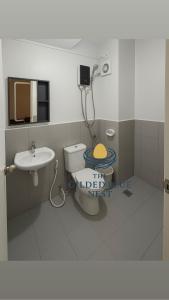 a bathroom with a toilet and a sink at The Gilded Blue Nest in Mandaue City +26 photos