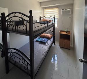 a couple of bunk beds in a room at The Gilded Blue Nest in Mandaue City
