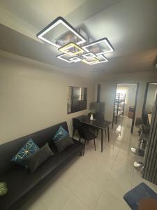 a living room with a couch and a table at The Gilded Blue Nest in Mandaue City