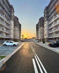 a parking lot with cars parked in front of tall buildings at Ap Go travel in São Luís