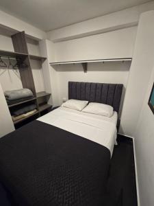 een slaapkamer met een groot bed met een zwart hoofdeinde bij Pipe's House in Salento