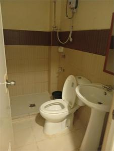 a bathroom with a toilet and a sink at WJV INN LAHUG in Cebu City +9 photos