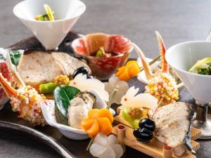 a plate of food with sushi and other foods at KAMENOI HOTEL Genkainada in Kitakyushu