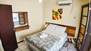 Ένα ή περισσότερα κρεβάτια σε δωμάτιο στο Água Marinha de Bombas - Bombinhas