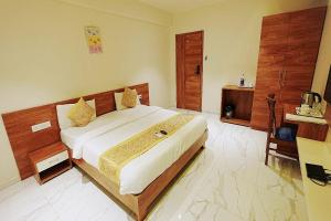 a bedroom with a bed and a telephone in it at LP Regency in Pune +40 photos