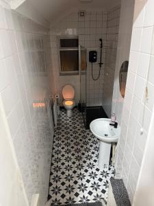 a bathroom with a toilet and a sink at Principality Stadium & City Centre on the Doorstep in Cardiff