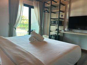 Ένα ή περισσότερα κρεβάτια σε δωμάτιο στο Sena Hotel Langkawi