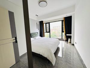 a bedroom with a bed and a large window at Xiaowo SmileNest Downtown Scenic Spot Ticket Service Close to Tianmen Mountain Scenic Area Ideal for Couples, Families and Group Bookings in Zhangjiajie