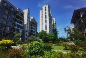 two tall buildings in a city at Xiaowo SmileNest Downtown Scenic Spot Ticket Service Close to Tianmen Mountain Scenic Area Ideal for Couples, Families and Group Bookings in Zhangjiajie