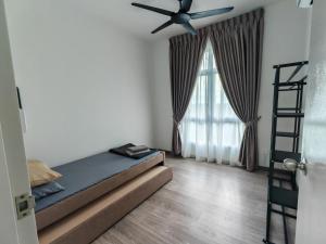 a bedroom with a bed and a ceiling fan at MIRAI Residences in Kajang