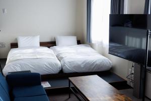 Giường trong phòng chung tại Maison Odori