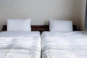 Giường trong phòng chung tại Maison Odori