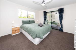 a bedroom with a bed with a teddy bear on it at Cascade View - 4 Bedroom House in Cascade