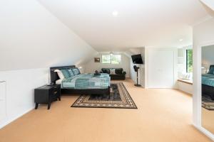 a bedroom with a bed and a couch at Cascade View - 4 Bedroom House in Cascade