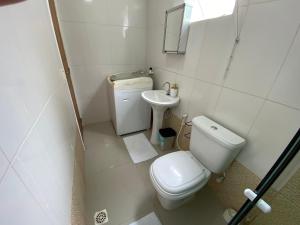 a small bathroom with a toilet and a sink at Casa independente em tuncuns in Búzios +11 photos
