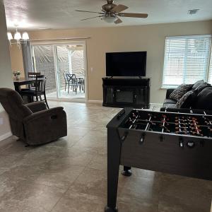 a living room with a foosball table in the middle at Casa Cortez C in Visalia