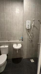 a bathroom with a toilet and a sink at 9 Beradik Homestay in Kajang