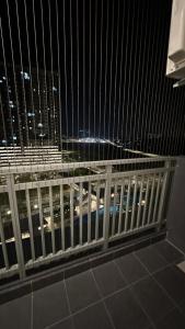 a view of a city at night through a fence at 9 Beradik Homestay in Kajang