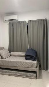 a bed in a room with a curtain at 9 Beradik Homestay in Kajang +2 photos