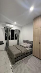 a bedroom with a large bed and a window at 9 Beradik Homestay in Kajang