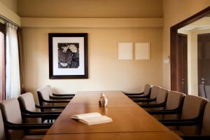 a conference room with a wooden table and chairs at Java Go Residence by Jiwa Jawa in Semarang