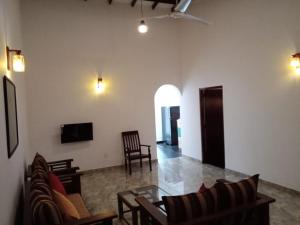 a living room with a couch and a table at Gin River View Point in Gintota