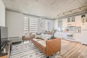 a living room with a couch and a kitchen at Skyline Sanctuary in Cleveland