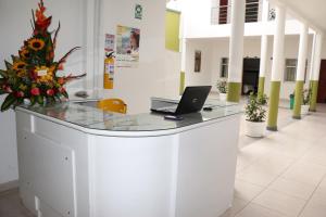 an office with a desk with a laptop on it at Hotel Abadia in Sogamoso